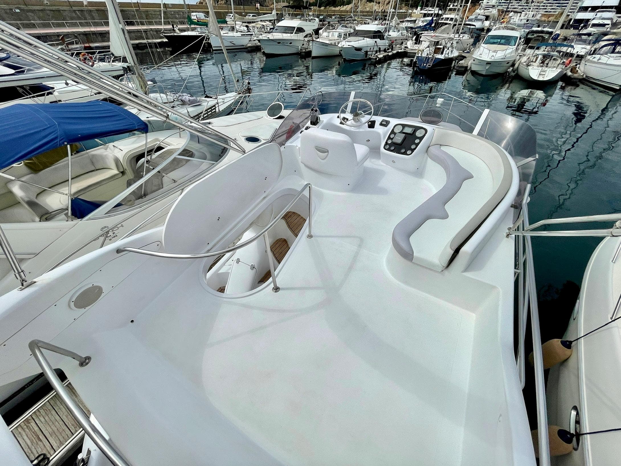 2006 Genesis Boats 37 Flybridge with spacious deck, docked in a marina with multiple boats.