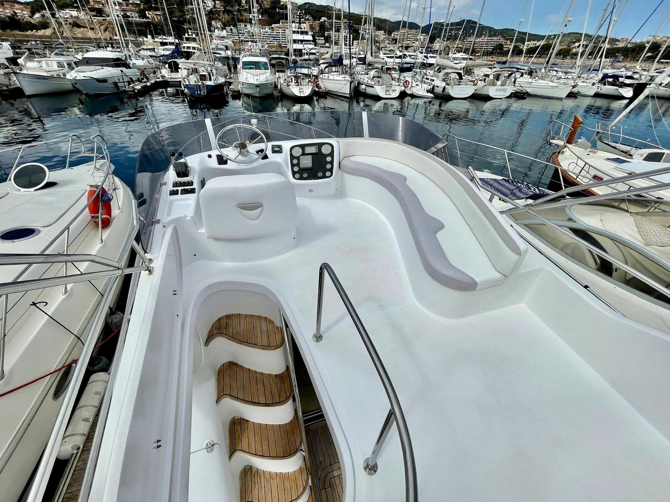 Flybridge view of 2006 Genesis Boats 37, docked in a marina with multiple yachts.