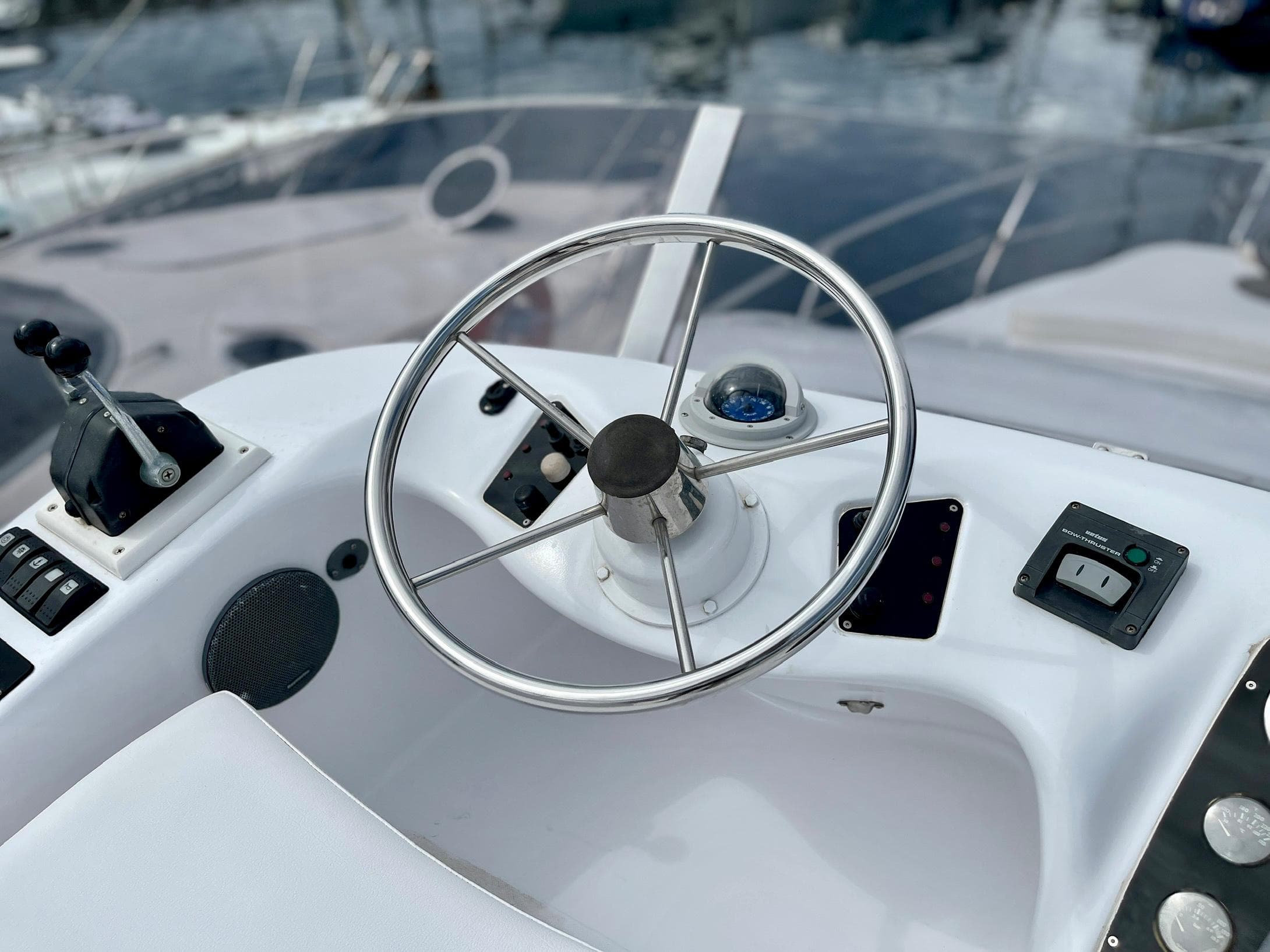 Steering wheel of 2006 Genesis Boats 37 Flybridge, featuring modern controls and sleek design.