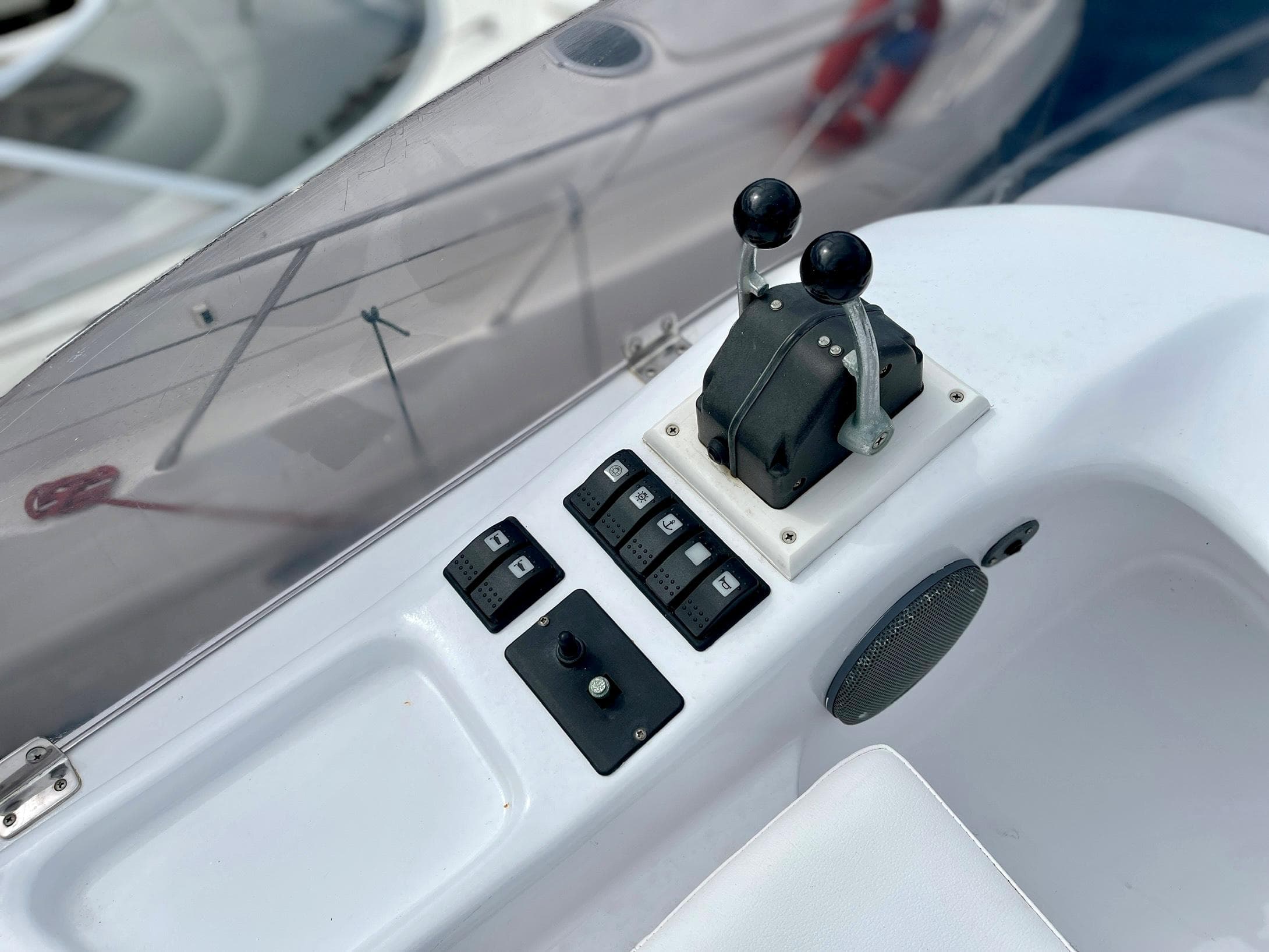 Control panel of a 2006 Genesis Boats 37 Flybridge with levers and switches.