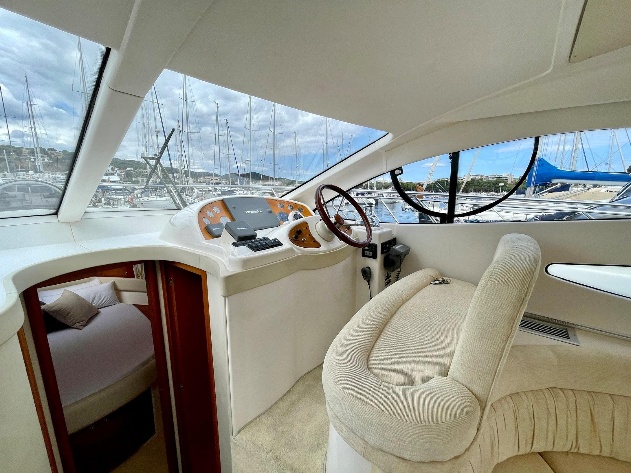 Interior of 2006 Genesis Boats 37 Flybridge, featuring helm and cabin entrance.