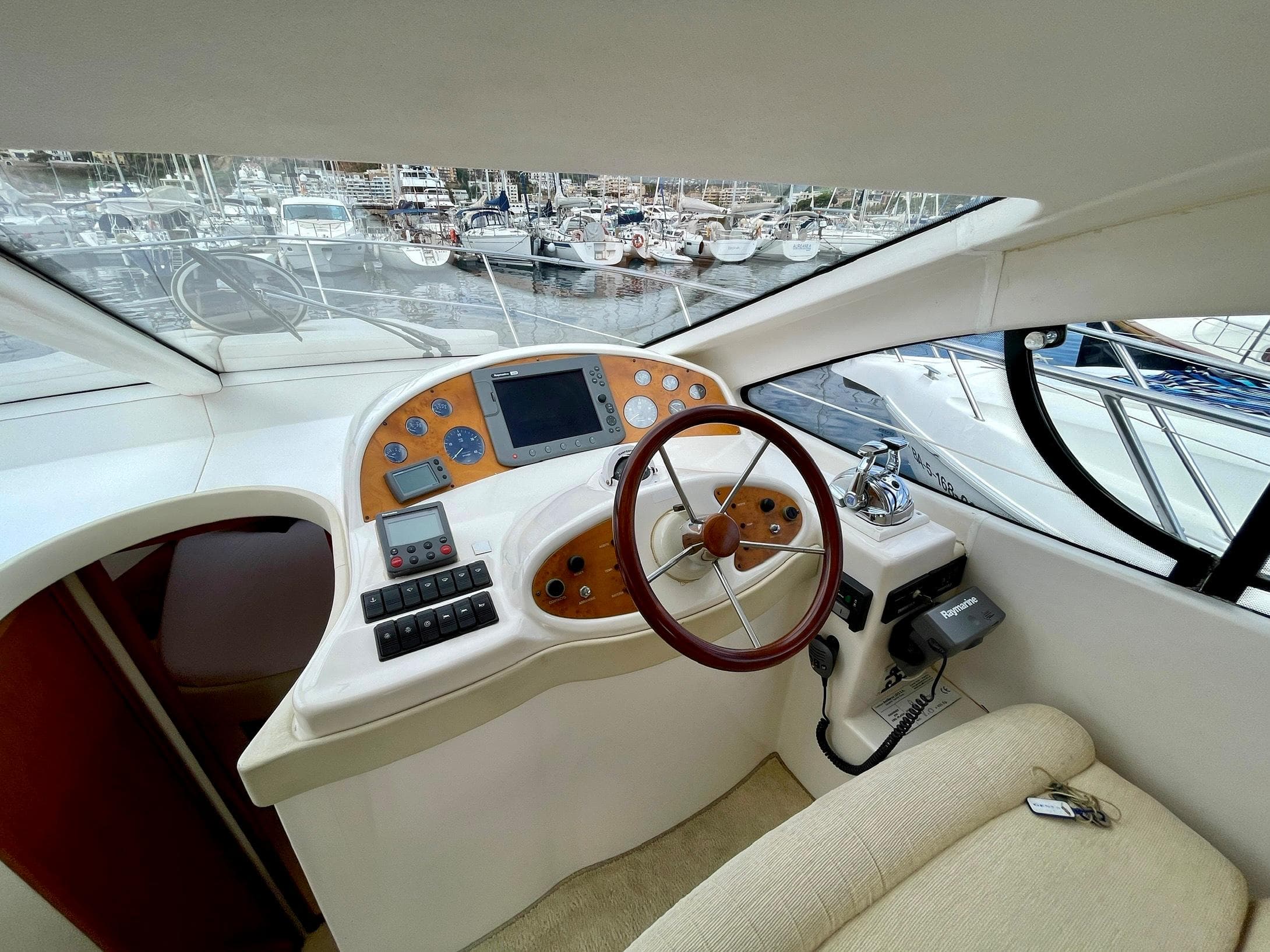 Helm of 2006 Genesis Boats 37 Flybridge with steering wheel and control panel.