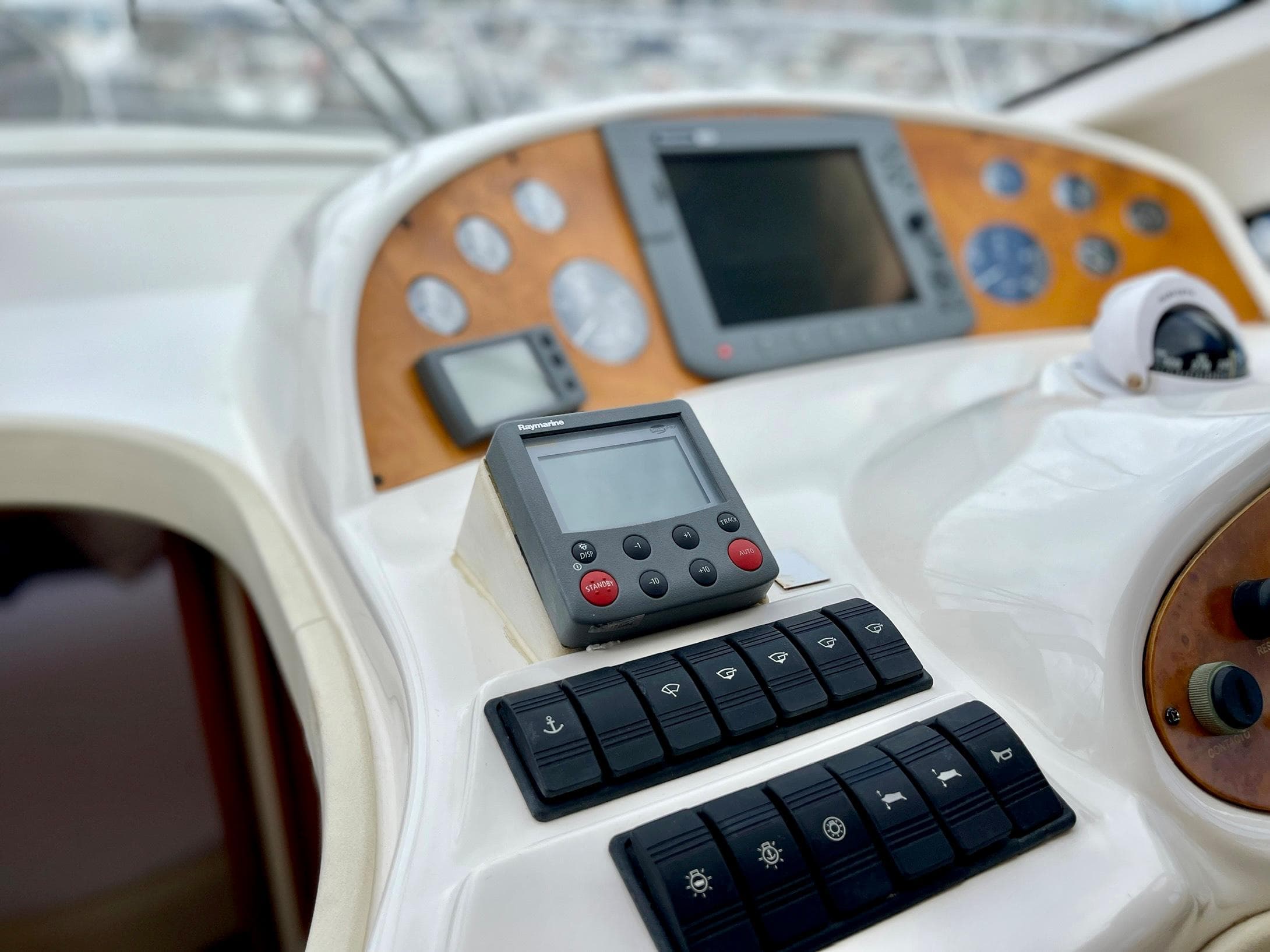 Control panel of 2006 Genesis Boats 37 Flybridge with navigation instruments and switches.