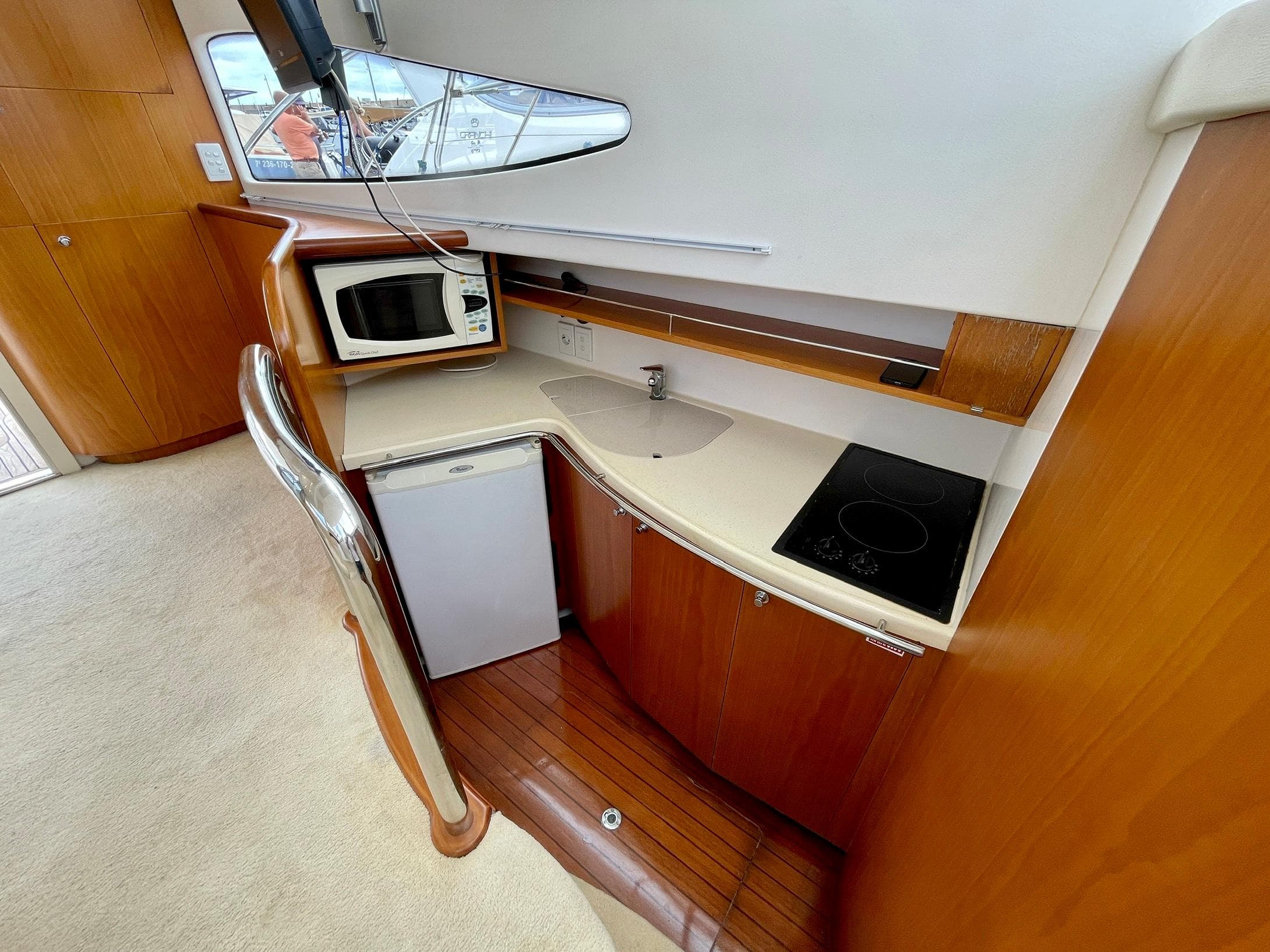 2006 Genesis Boats 37 Flybridge kitchen with microwave, fridge, sink, and stovetop.