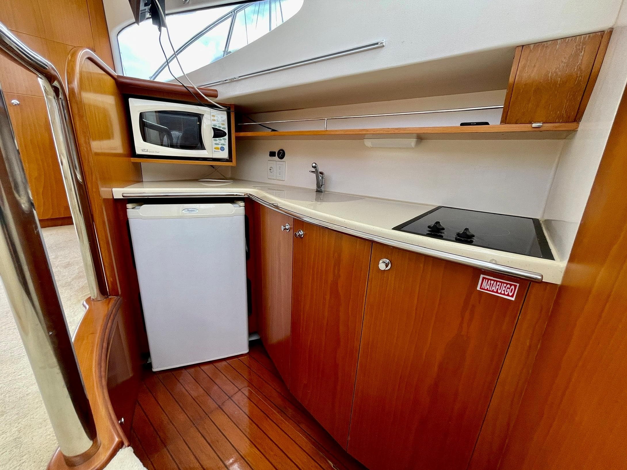 2006 Genesis Boats 37 Flybridge kitchen with microwave, fridge, and stove.