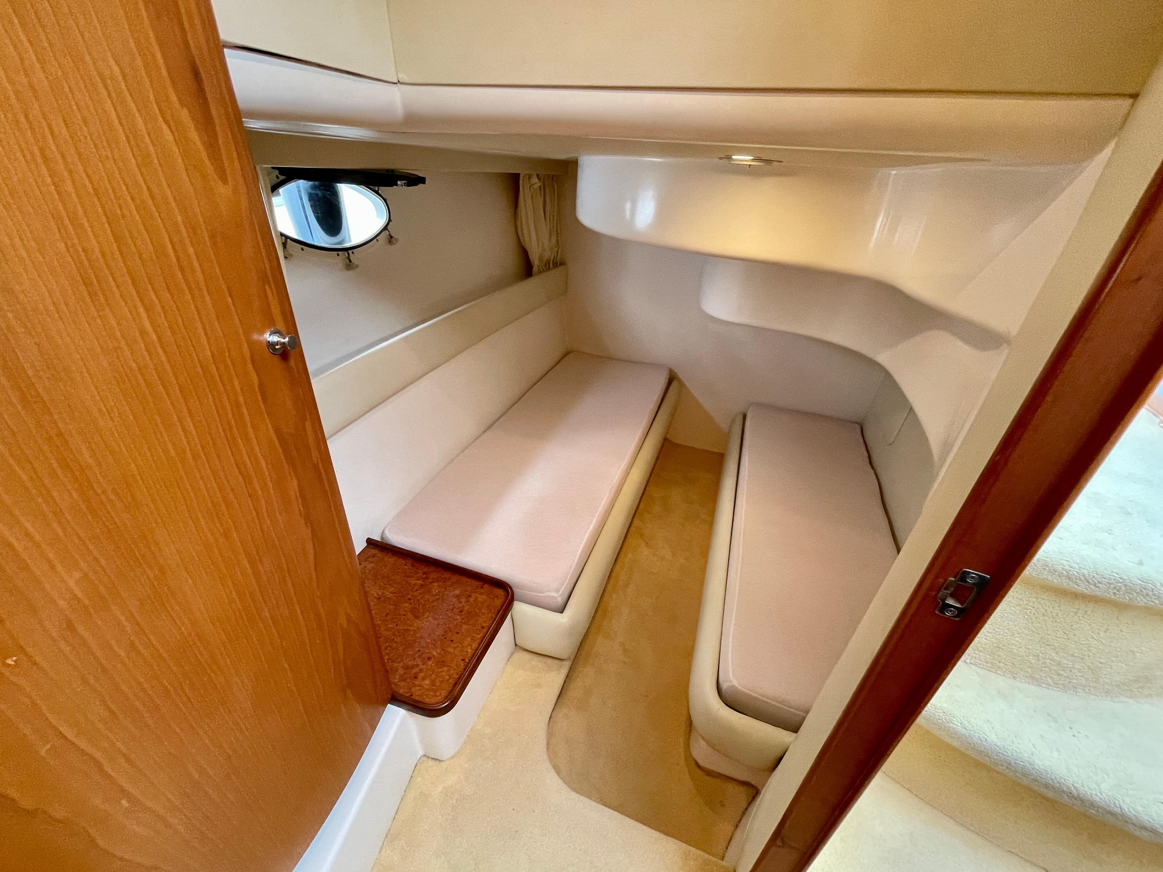 2006 Genesis Boats 37 Flybridge cabin interior with twin beds and wooden accents.