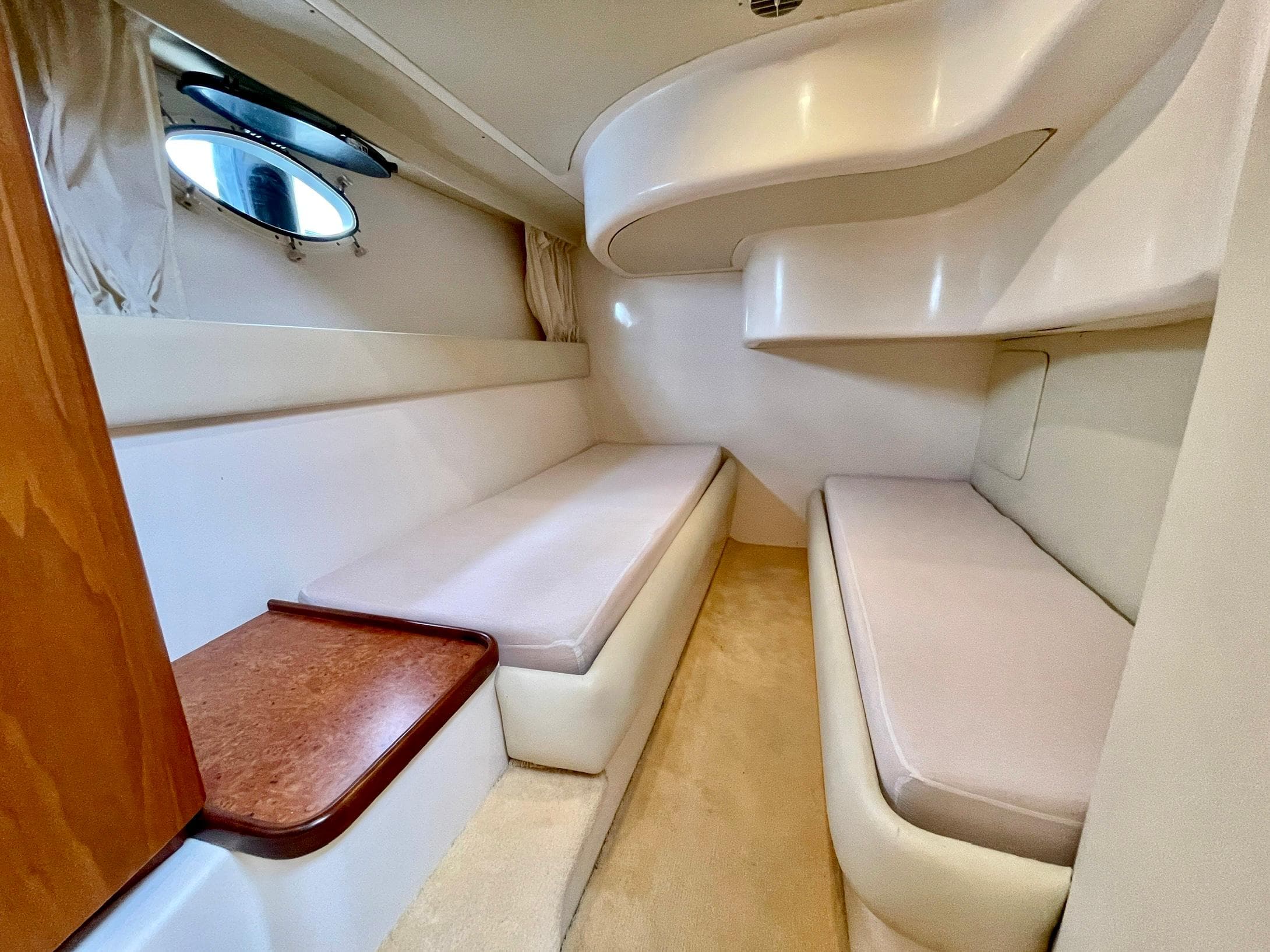 Interior cabin of 2006 Genesis Boats 37 Flybridge, featuring cozy seating and modern design.