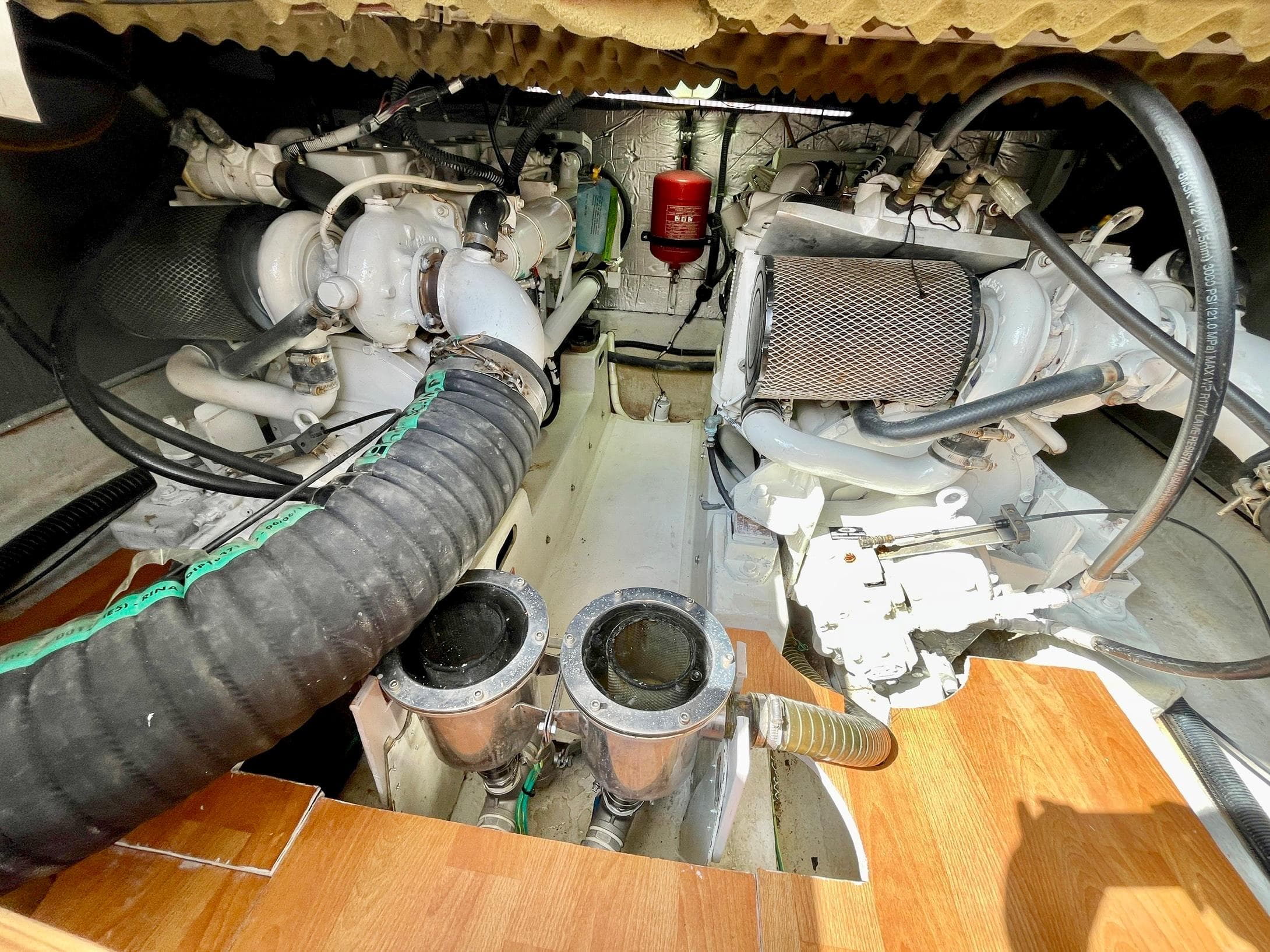 Engine room of 2006 Genesis Boats 37 Flybridge with visible components and hoses.