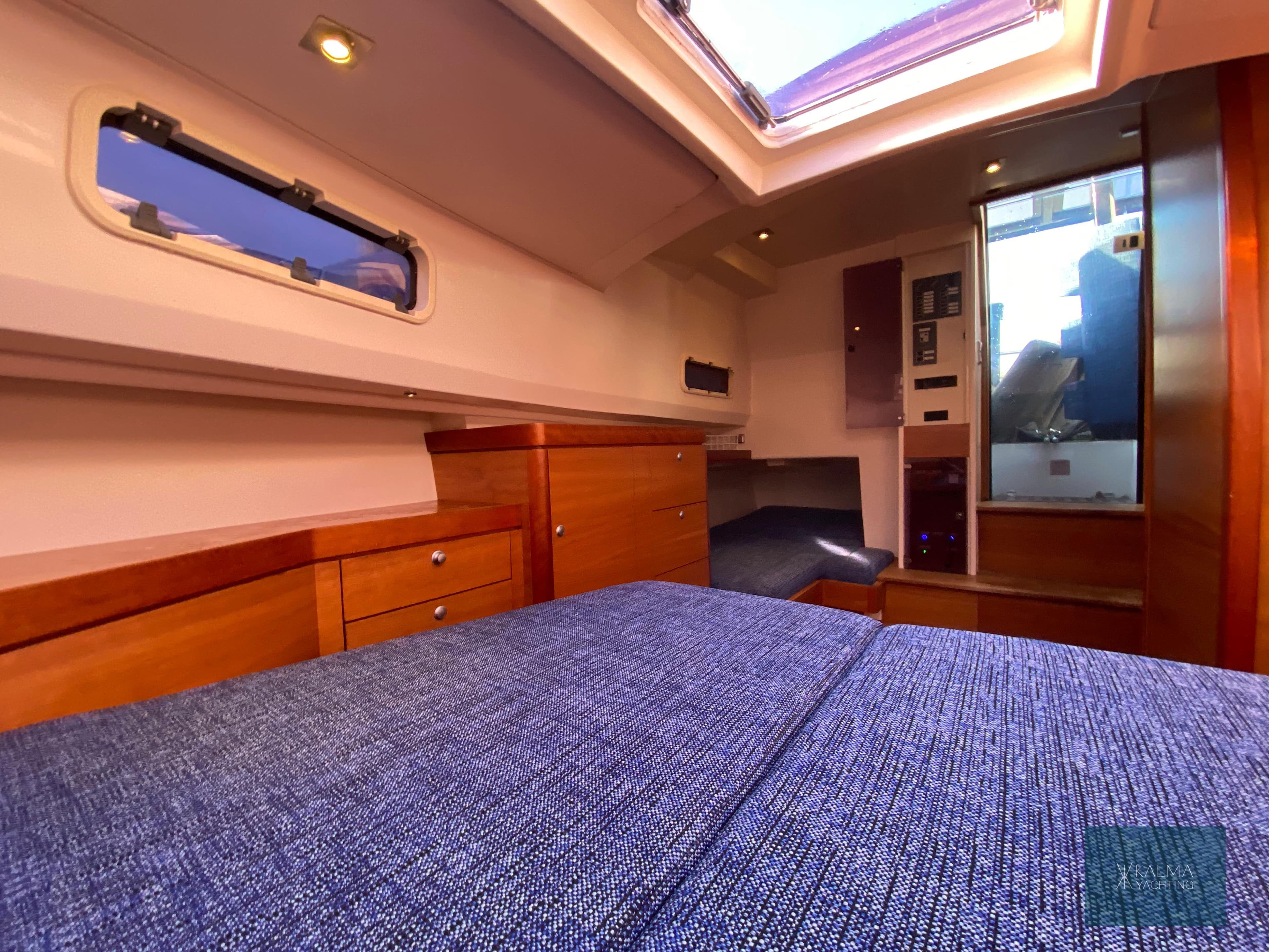 Interior of 2008 Fjord 40 Open yacht with wooden furnishings and skylights.