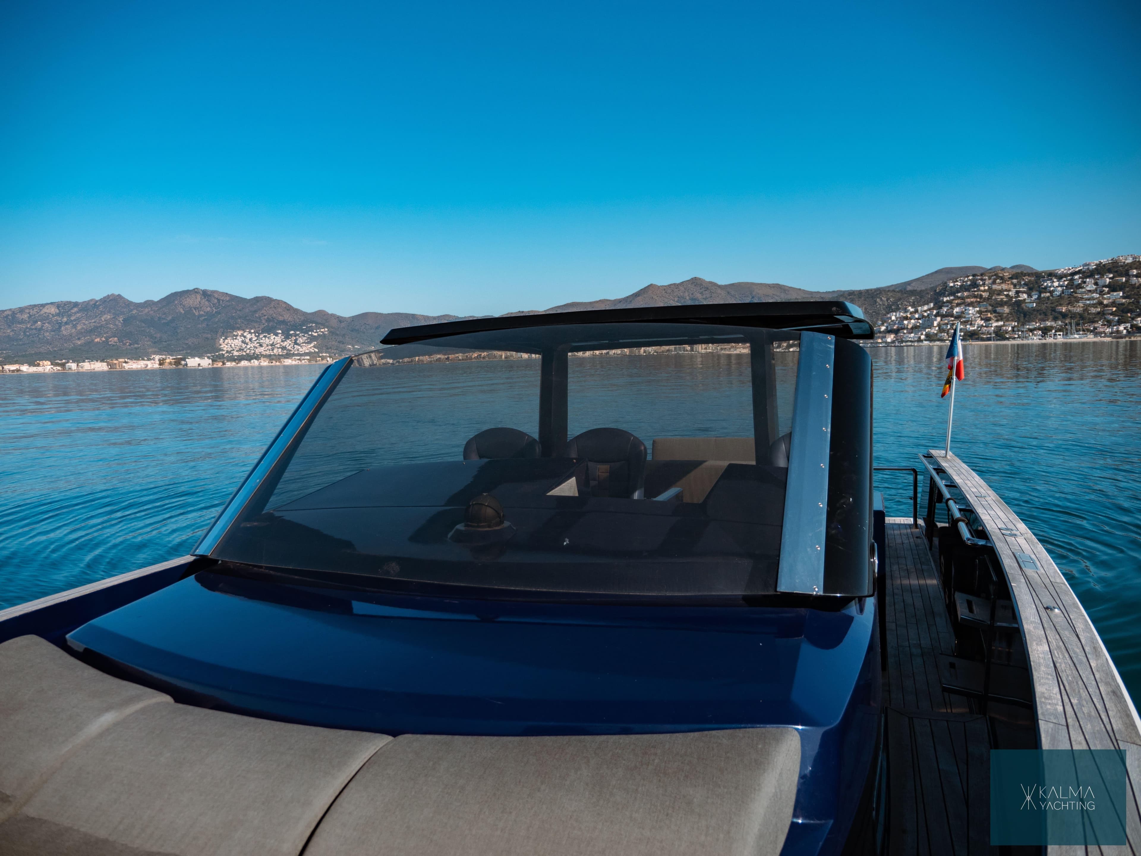 Fjord 40 Open 2008 on calm water with mountain backdrop.