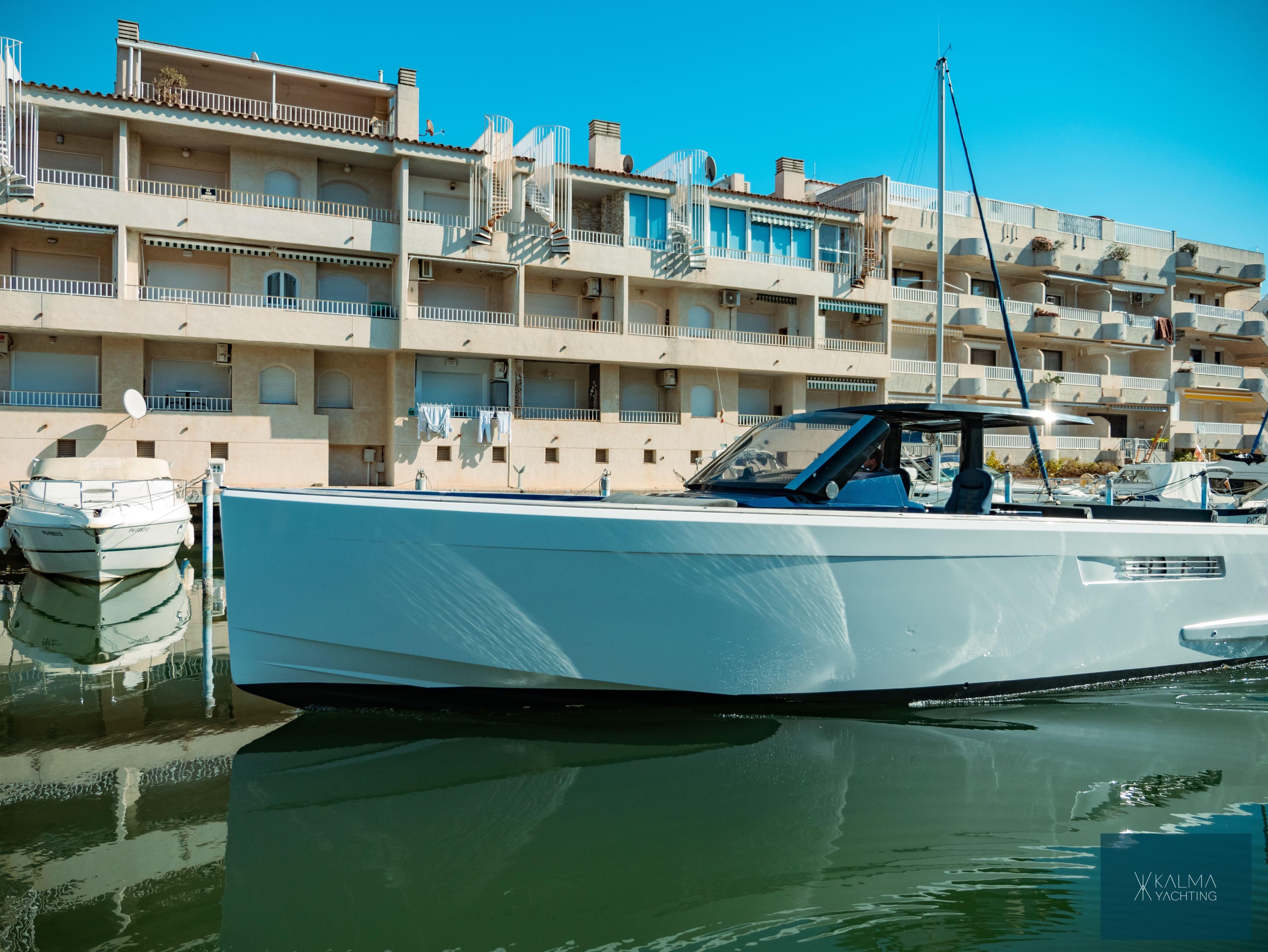 2008 Fjord 40 Open yacht docked near modern apartments.
