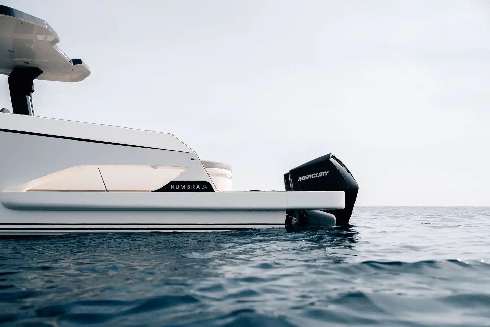 2026 Kumbra 36 boat with Mercury engine on calm sea.