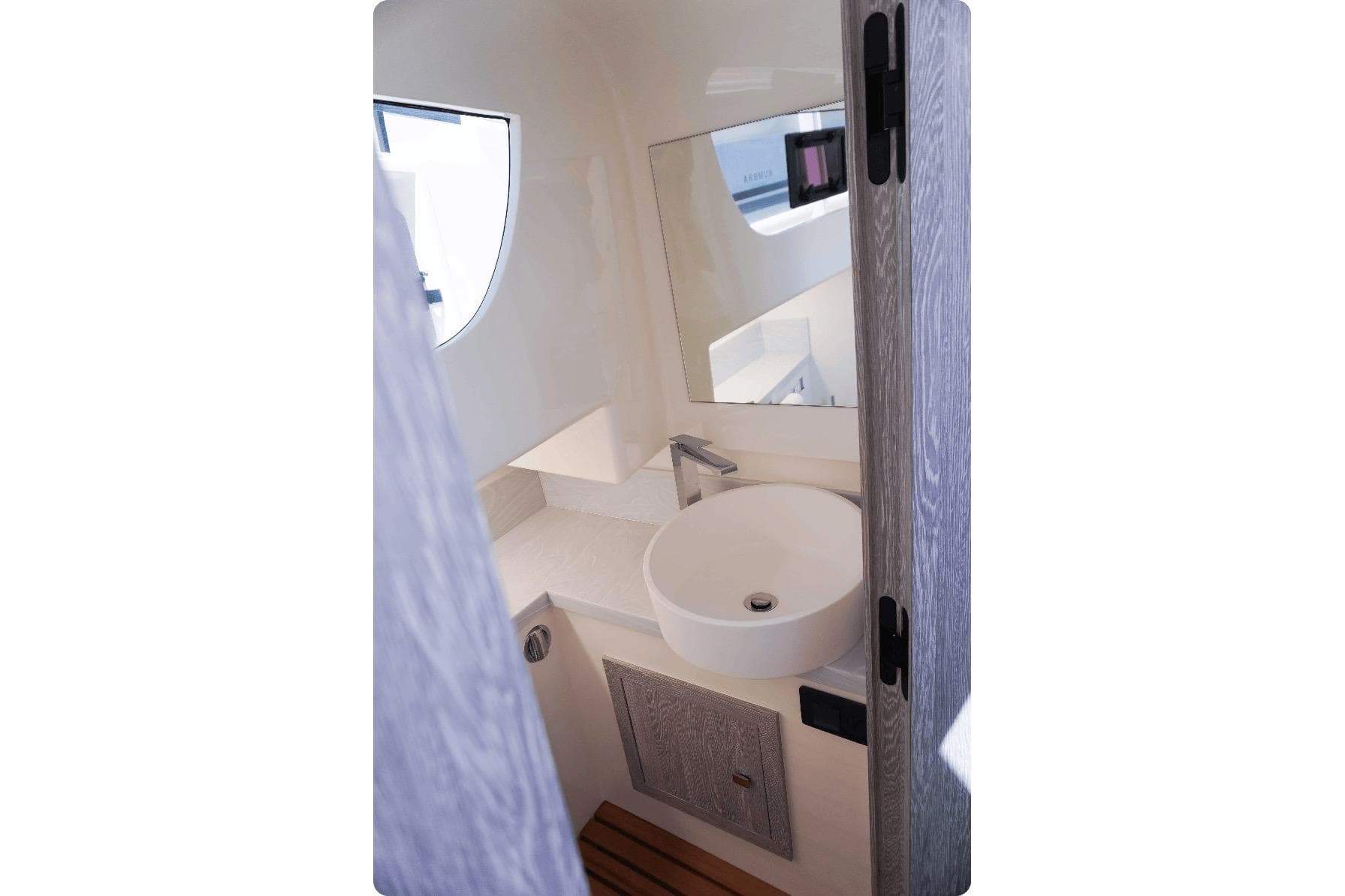 Modern bathroom interior in 2026 Kumbra 36 boat, featuring sleek sink and mirror.