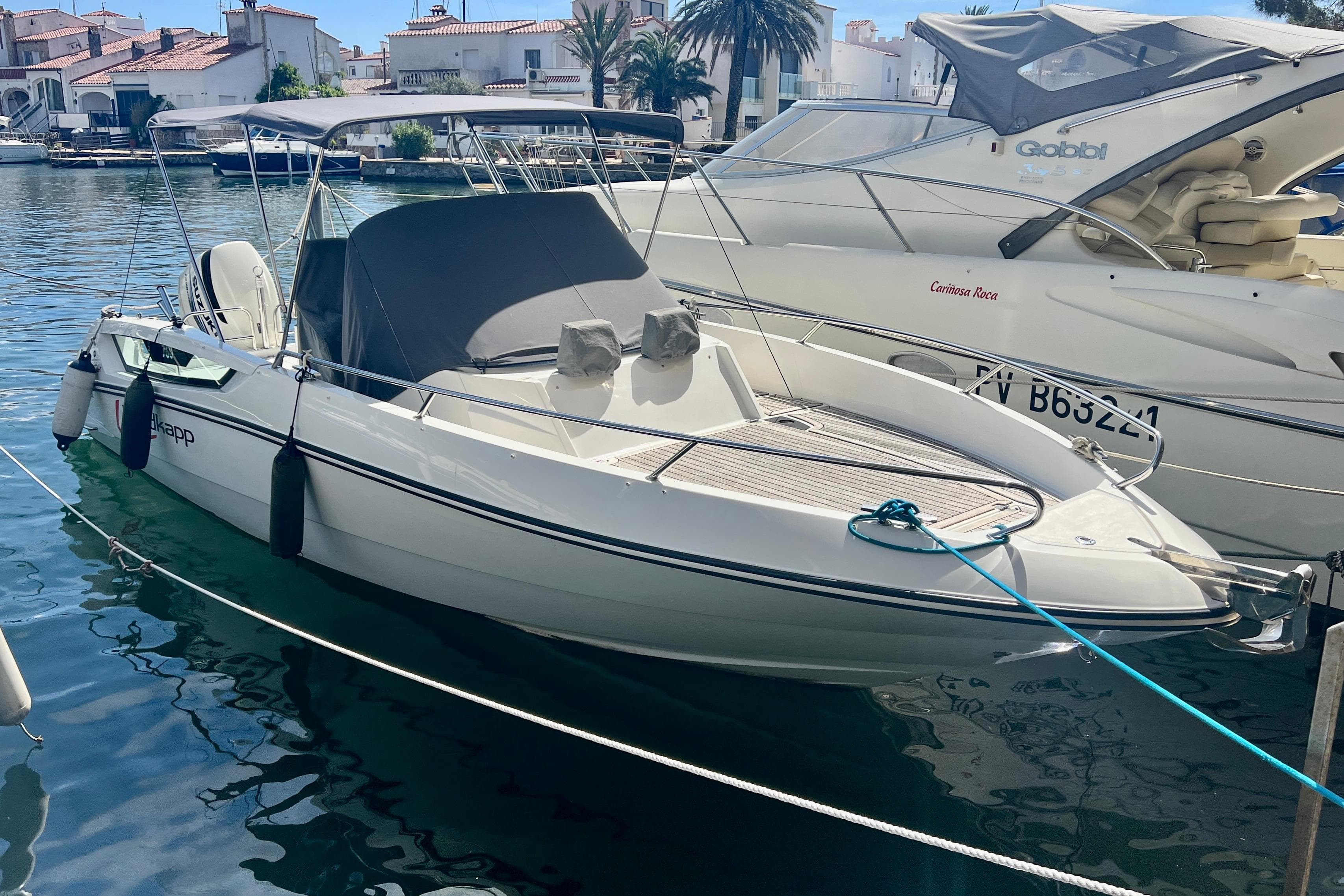2014 Nordkapp Enduro boat docked in a marina, featuring sleek design and canopy.