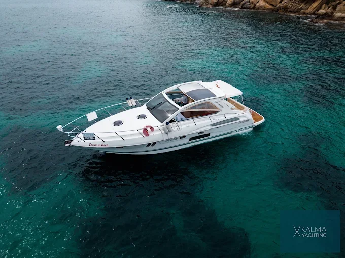 Cruiser anchored in the turquoise water of the Costa Brava
