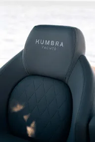 Upholstered seat with the Kumbra Yachts logo