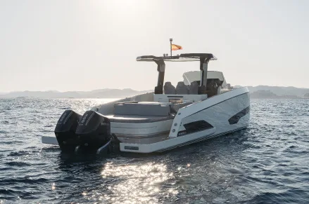 Kumbra 34 with twin outboard engines on a sunlit sea